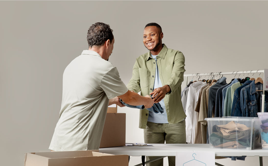 Two people shaking hands in a clothing store