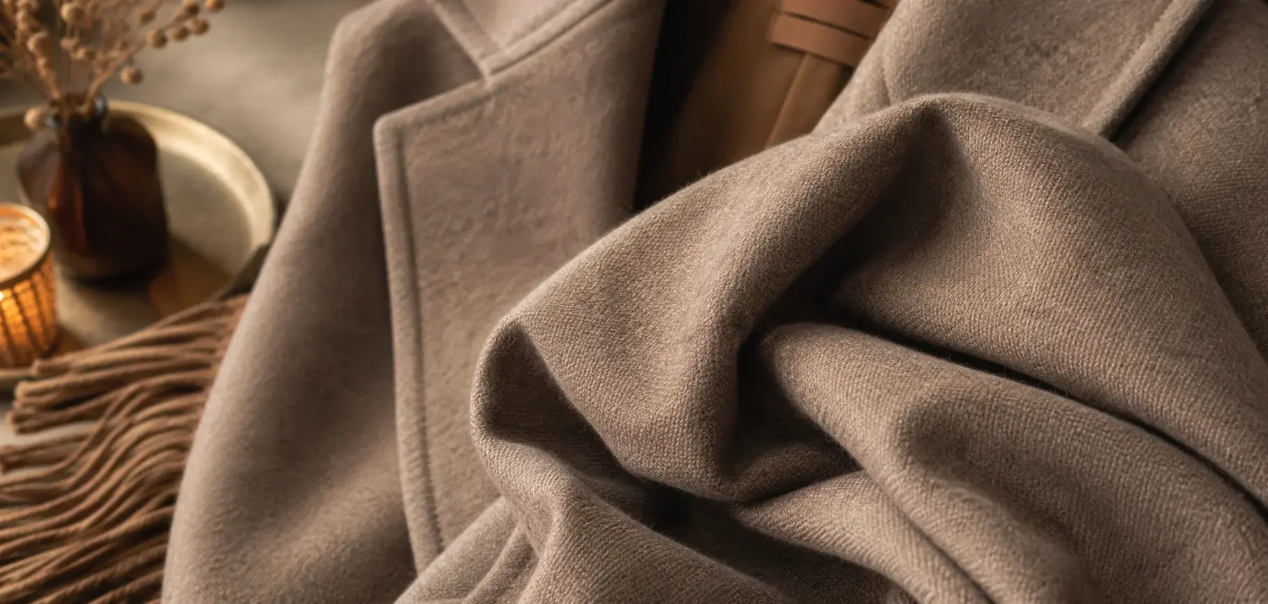 Soft taupe viscose wool fabric with a warm textured finish and elegant draped folds.