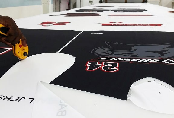 A man is preparing to make a sublimation baseball jersey