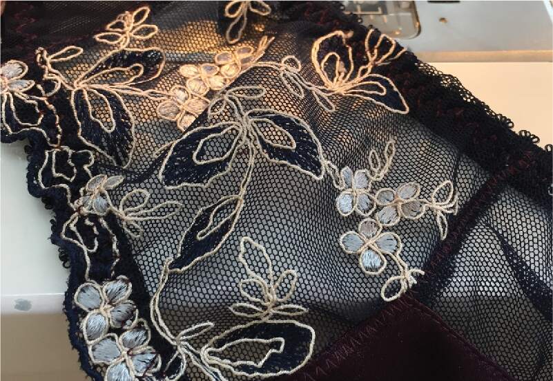 Piece of black lace on a sewing machine