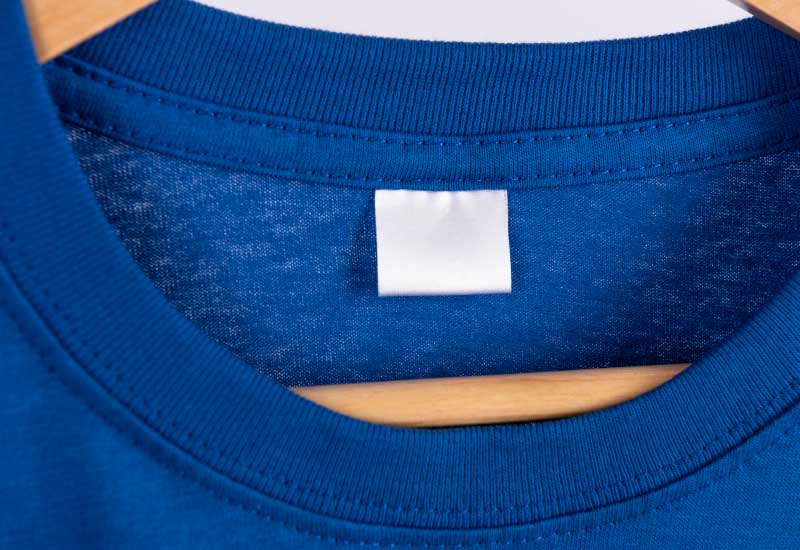 A blank white label is stitched onto the inside back collar of the shirt